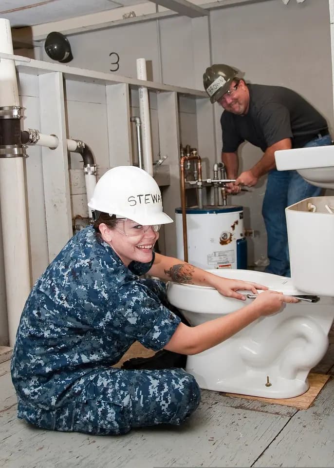 A US construction worker assembling a toilet tank in Texas