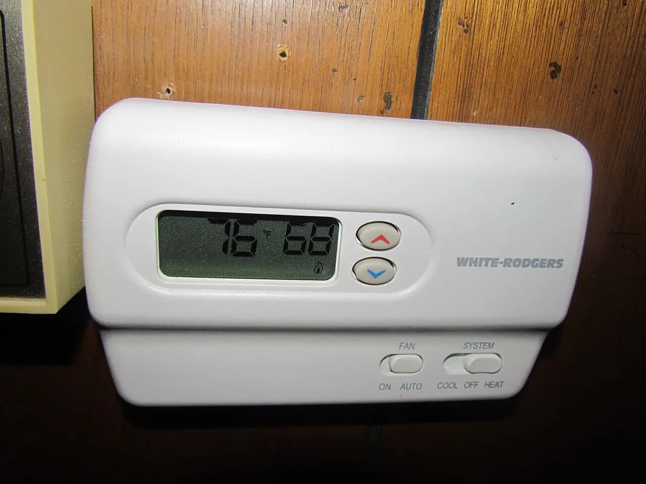 A wall-mounted heating and air-conditioning thermostat