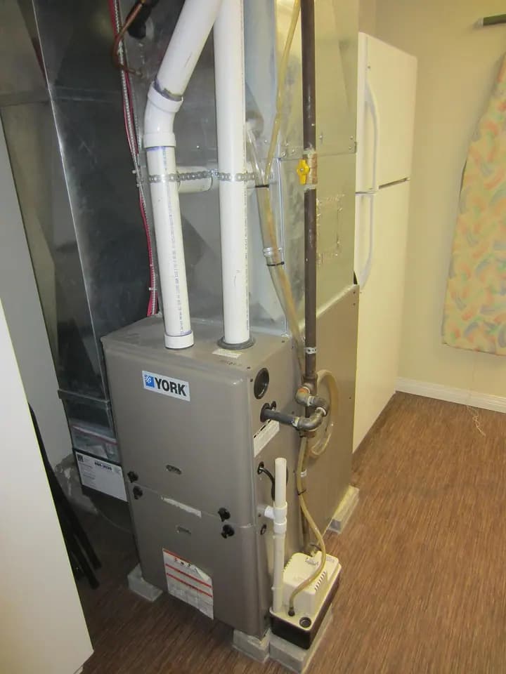 A condensing forced-air gas furnace and connected ductwork